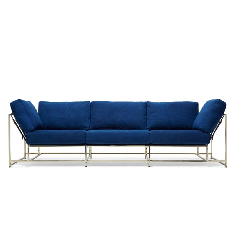 Utilizing the same hand-dipped, naturally dyed indigo canvas from the Stephen Kenn + Simon Miller collection, this sofa pairs it with a modern polished brass frame finish, indigo webbing, and cognac leather belts.